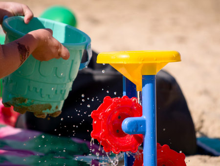 beach sea children playing with sand and waterの写真素材