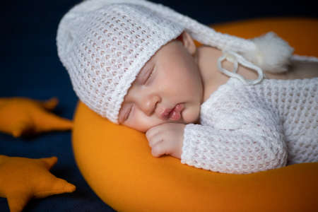 newborn baby sleeps in a sleep cap. close up.の写真素材