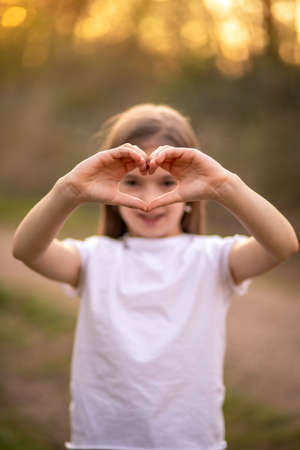 cute girl showing a heart with her hands.の写真素材