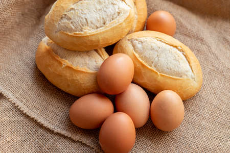 eggs and buns lie in burlap. Fresh fragrant bread and egg.の写真素材