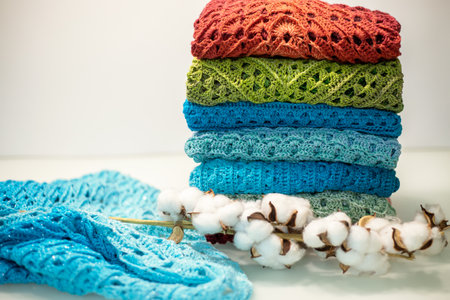 a stack of multi-colored knitted things on a white background.の写真素材