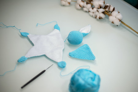 knitted toy bunny in the process of making with your own hands.の写真素材