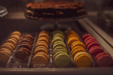 multi-colored macaroons red, yellow, blue, green, orange colors on the counter in the store.