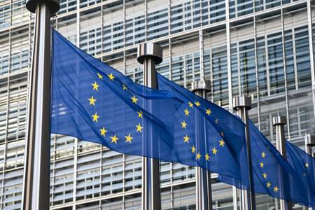 EU flags in front of a glass building.の素材
