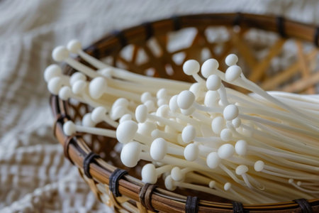 Enoki mushrooms in a basket. The natural and delicate beauty of fresh enoki mushrooms, a healthy culinary ingredientの素材