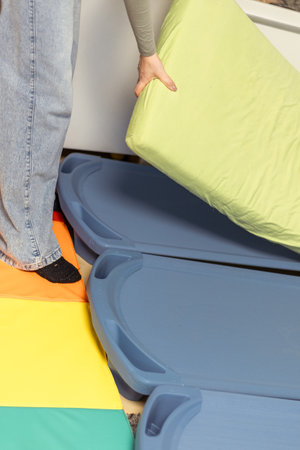 Preparing colorful mats for a fun childrens activity in a playroom during the afternoonの写真素材