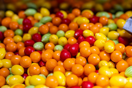 Colorful assortment of candy displayed at a market during daytime in a vibrant settingの写真素材