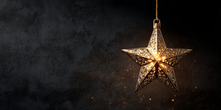 Decorative star pendant light illuminating a dark wall with intricate patterns and warm glowの素材
