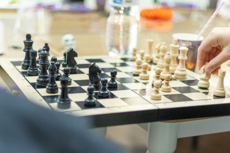 Strategic chess match in a casual setting with players focused on their next movesの写真素材