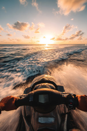 Exciting jet ski ride over waves at sunset along the coast with vibrant clouds and sparkling ocean watersの素材