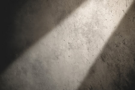 Light streams through cracks in a dark room, creating dramatic shadows on the textured wall surfaceの素材