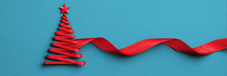 Creative red ribbon Christmas tree design on a blue background offering festive inspiration for holiday decorationsの素材