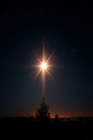 Bright star shines over a calm landscape at night with twinkling sky and silhouettes of treesの素材