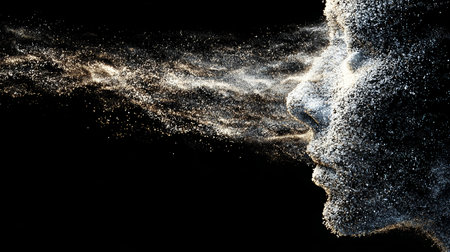 Artistic depiction of a human face created from shimmering particles against a dark background showcasing ethereal beautyの素材