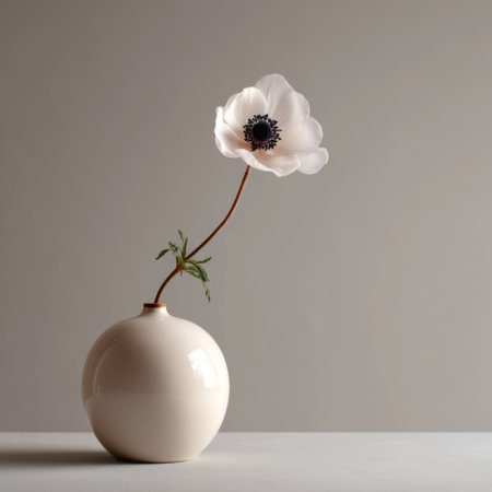 Elegant white flower in a minimalist vase placed on a clean surface with soft natural lighting during the dayの素材