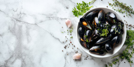 Freshly cooked mussels served in a white bowl with herbs and garlic on a marble countertopの素材