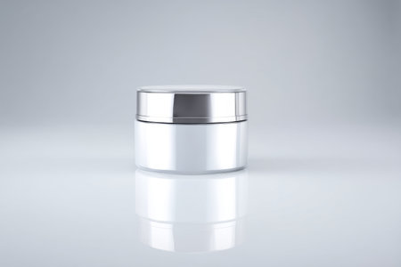 Sleek jar with silver lid displayed on a clean surface in a bright, neutral settingの素材