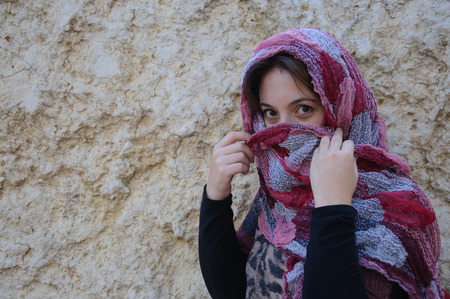 Eastern woman with traditional veil, eyes intense, mystical beautyの写真素材