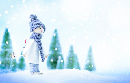 toy girl skiing in winter forestの写真素材