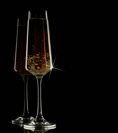 two glasses of champagne on a black backgroundの写真素材
