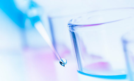 a drop of liquid on the syringe needle and test tubes in a row. double exposureの写真素材