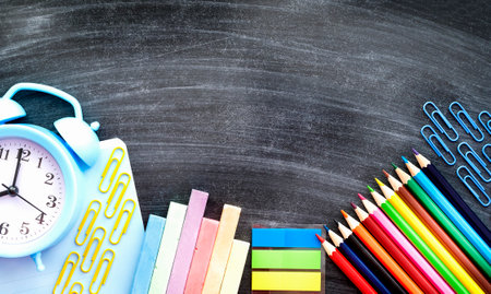 schoolboy stationery on the background of the blackboardの写真素材