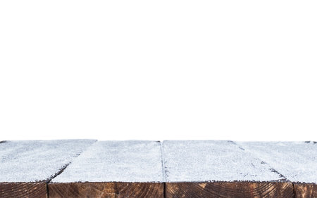 wooden planks covered in snow on white isolated backgroundの写真素材
