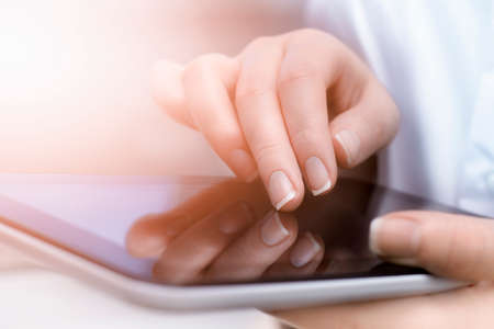 woman uses a digital tablet. extremely close-up.の写真素材