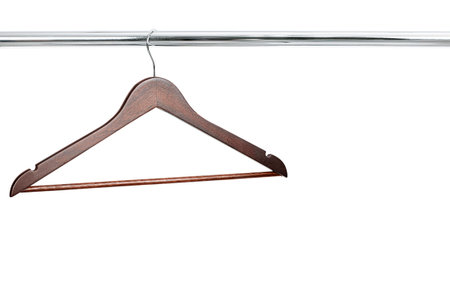 one wooden hanger hanging on a metal crossbar. isolated on white backgroundの写真素材