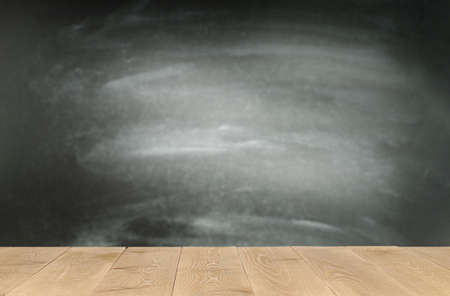 blackboard and wooden table with copy spaceの写真素材
