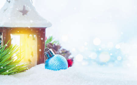 christmas ornament and candlestick in winter snowの写真素材