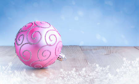 pink christmas ornament on wooden tableの写真素材