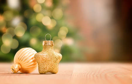 christmas decorations on a wooden table against the background of a christmas treeの写真素材