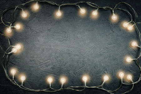 christmas light bulbs on dark gray concrete with copy spaceの写真素材