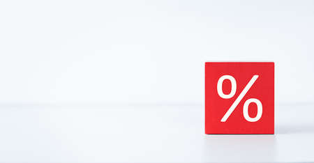 red cube with percent sign on light background, discount and sale conceptの写真素材