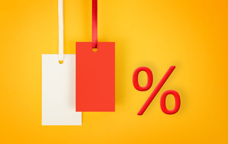 white and red labels and percent sign on yellow background, concept of discounts and sales with copy...