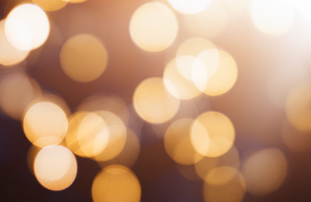 abstract festive background golden bokeh, close up on dark background