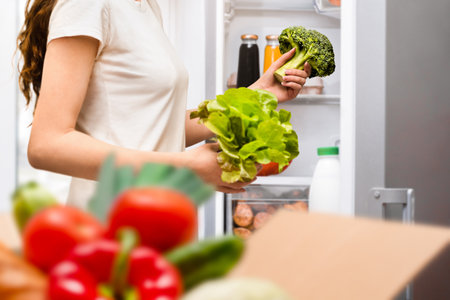 woman puts food in the refrigeratorの写真素材