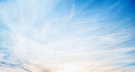 blue sky with clouds and setting sun