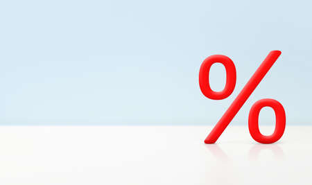 one red percent sign on light blue background with copy spaceの写真素材