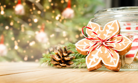 christmas gingerbread in the form of snowflakes on a wooden table against the background of a...