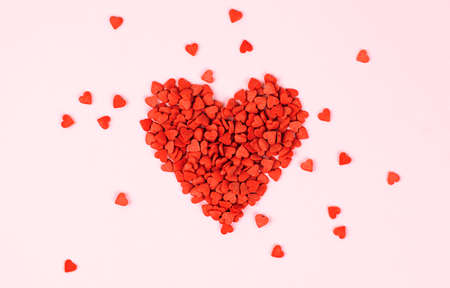 laid out heart of small hearts on a pink backgroundの写真素材