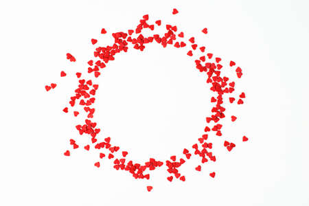 small hearts are scattered in the shape of a circle on a light background, a design element for valentine's dayの写真素材