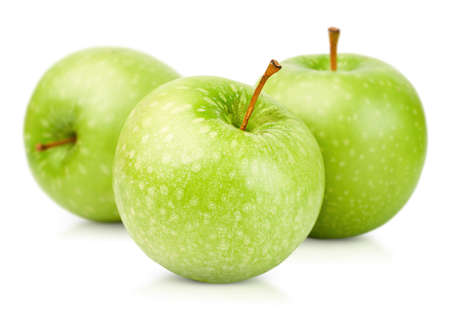 three green apples on a white isolated backgroundの写真素材
