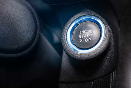 button start stop in the car on a dark background of the interior