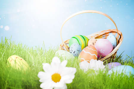 basket with scattered Easter eggs in the grassの写真素材