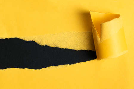 yellow torn paper with dark copy spaceの写真素材