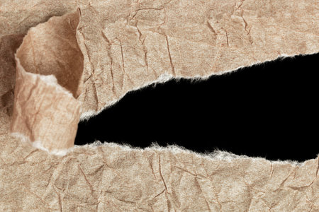 brown crumpled torn paper with copy space isolated on black