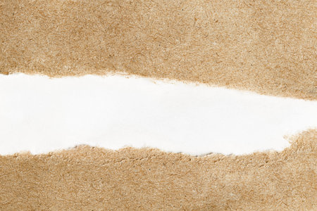 torn brown paper background with white copy spaceの写真素材