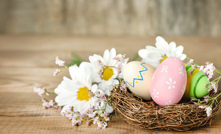 easter eggs and spring flowers on a wooden table